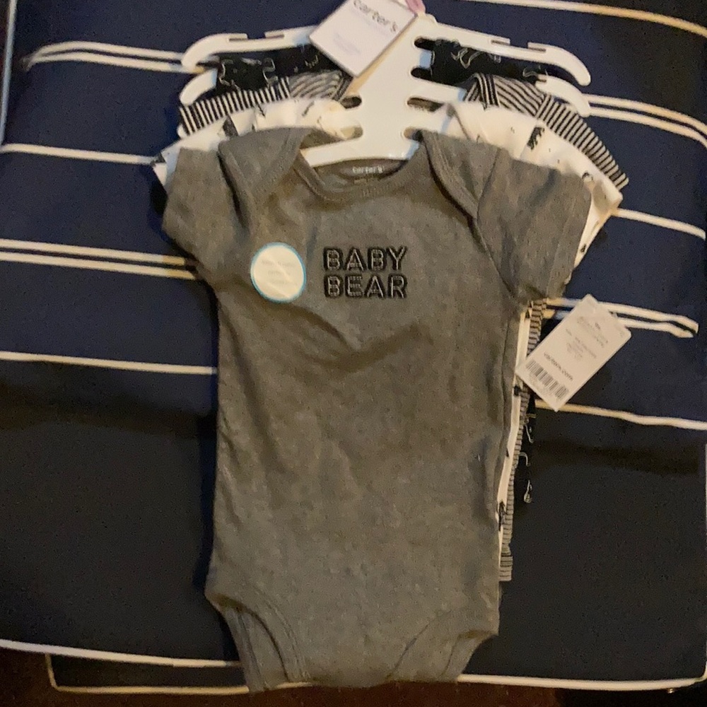 NWT. Carters 4 piece bodysuit set. 9M never worn